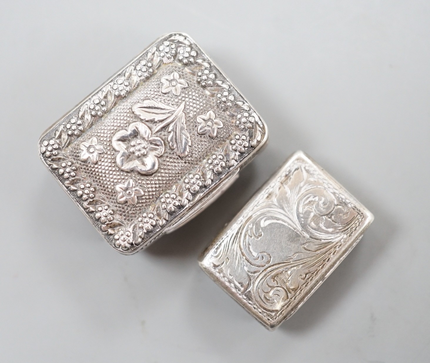 A George IV silver vinaigrette, embossed with flowers and flower heads, Ledsam & Vale?, Birmingham, 1820, 25mm and one other smaller Victorian silver vinaigrette, by Edward Smith.